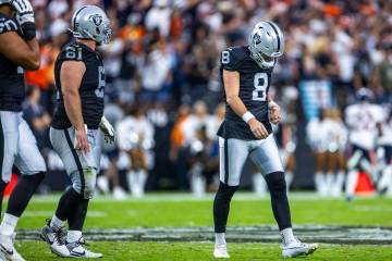 Raiders kicker Daniel Carlson (8) looks down after a deflection by Chicago Bears cornerback Jos ...