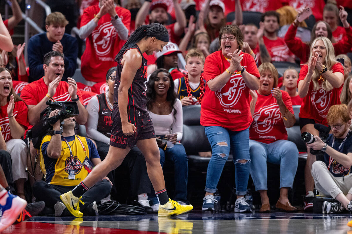 Indiana Fever guard Shey Peddy, front left, reacts after being fouled during the first half of ...