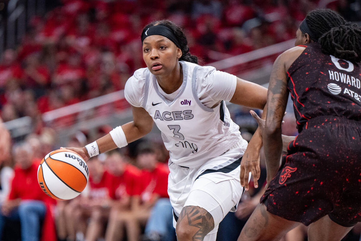 Las Vegas Aces forward NaLyssa Smith (3) drives against the defense of Indiana Fever forward Na ...
