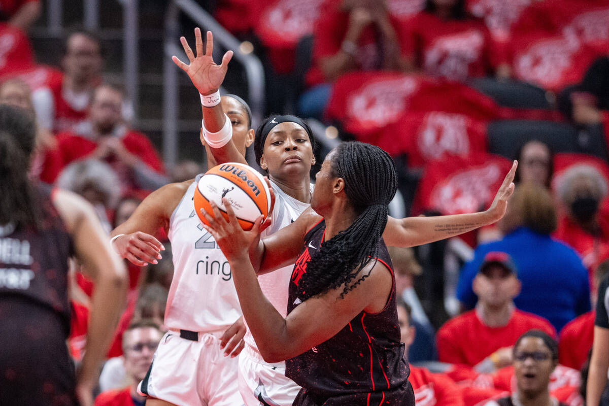 Las Vegas Aces forward NaLyssa Smith, back right, reaches out to block a shot-attempt by Indian ...