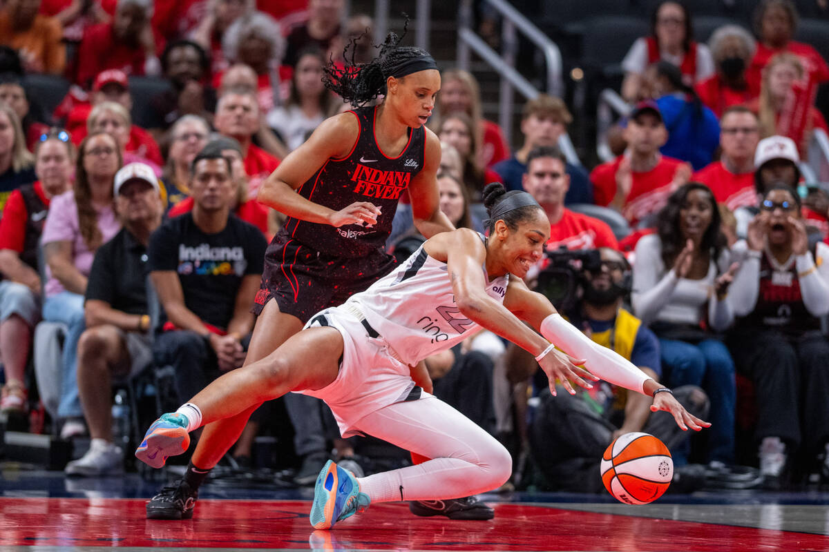 Las Vegas Aces center A'ja Wilson (22) dives for the ball while defended by Indiana Fever ...