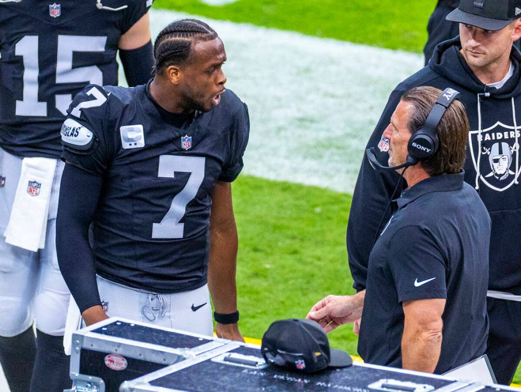 Raiders quarterback Geno Smith (7) talks with quarterbacks coach Greg Olson on the sidelines af ...