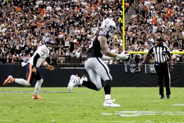 Raiders defensive end Maxx Crosby (98) intercepts a pass from Chicago Bears quarterback Caleb W ...