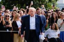 President Donald Trump walks to speak with reporters after greeting supporters before departing ...