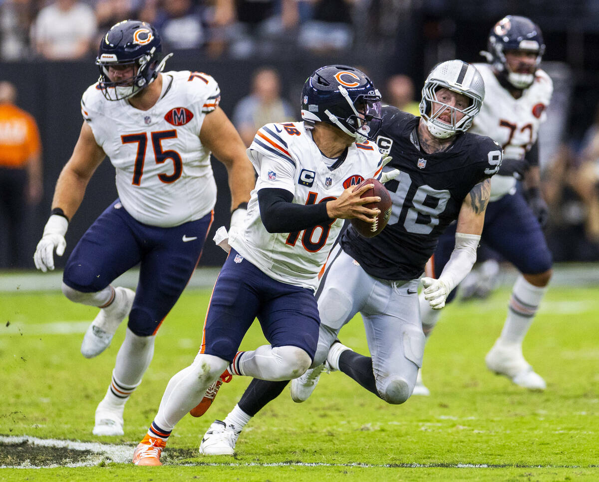 Raiders defensive end Maxx Crosby (98) harasses Chicago Bears quarterback Caleb Williams (18) ...