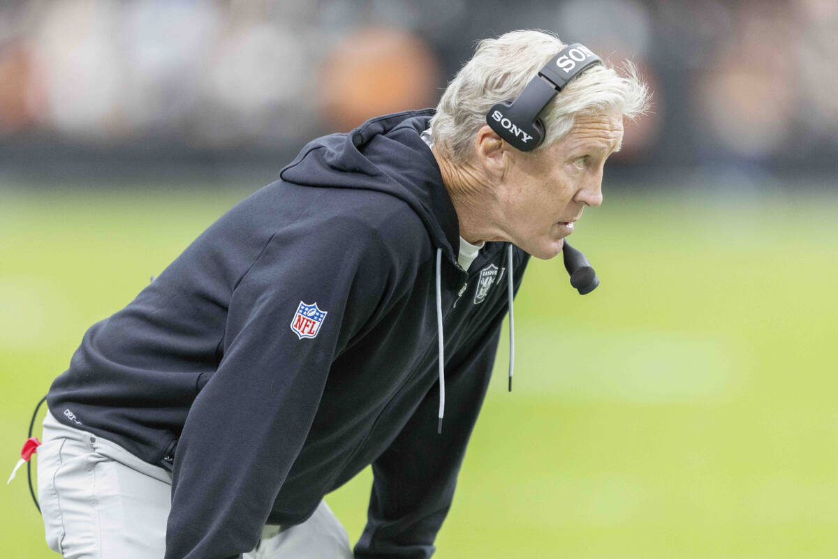 Raiders head coach Pete Carroll walks the sideline during the first half of an NFL game against ...