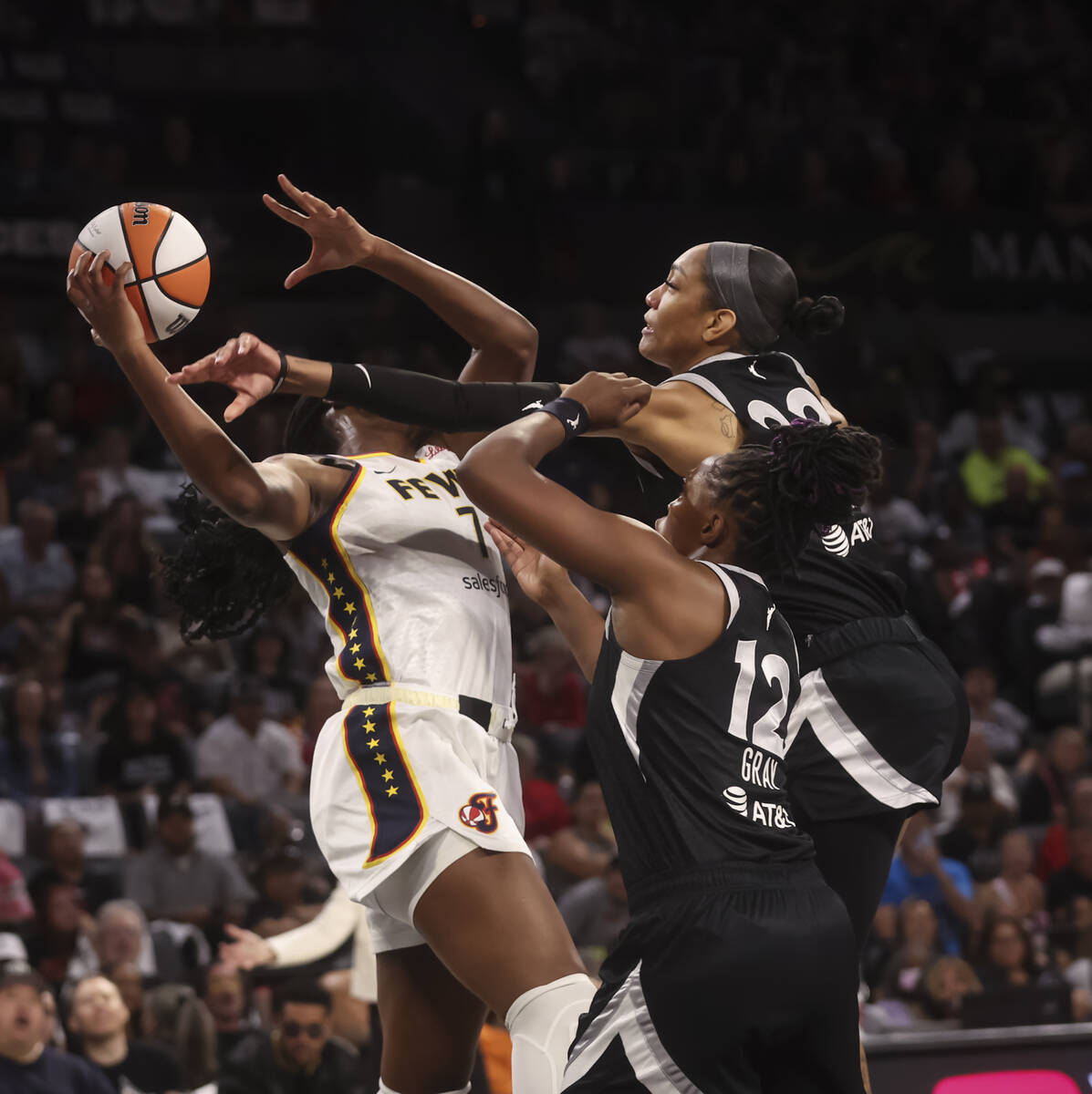 Indiana Fever forward Aliyah Boston (7) tries to hold onto a rebound against Aces center A&#039 ...