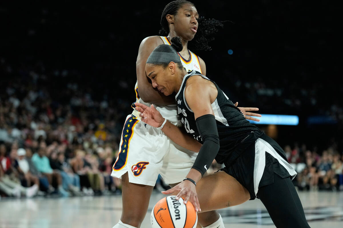 Las Vegas Aces center A'ja Wilson (22) drives against Indiana Fever forward Aliyah Boston ...
