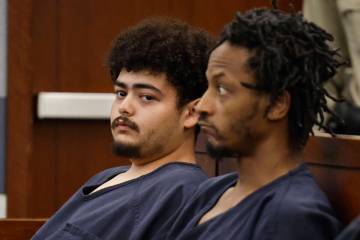 Jaime Bustillos, left, accused of shooting at Las Vegas police, appears at his bail hearing Mon ...