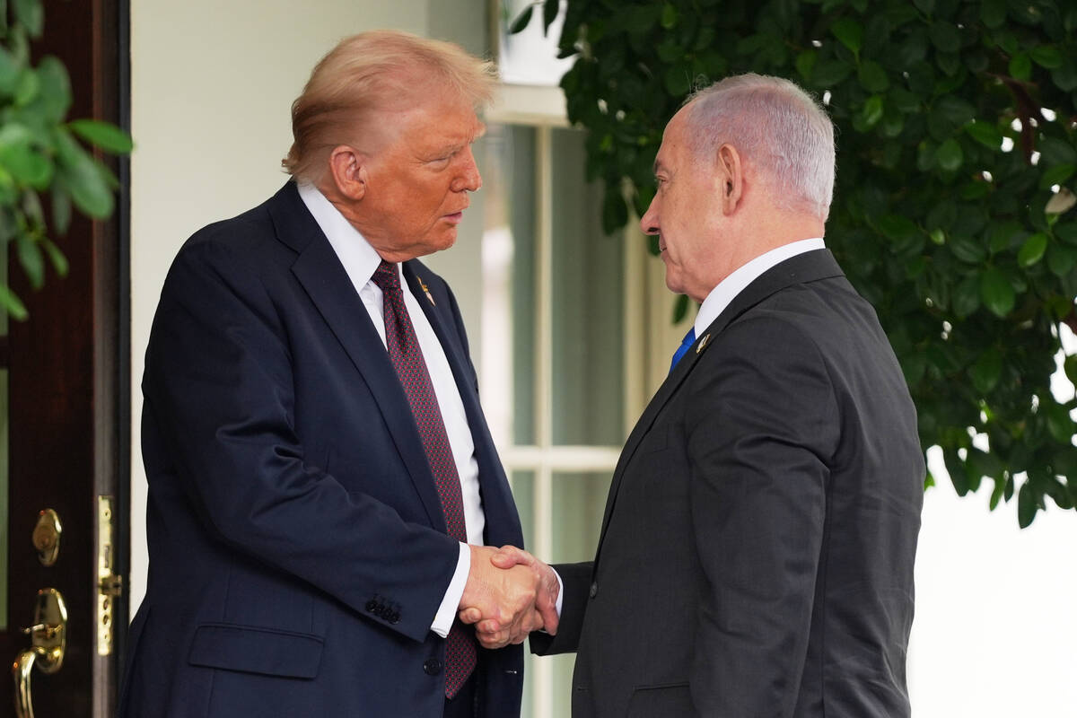 President Donald Trump, left, shakes the hand of Israeli Prime Minister Benjamin Netanyahu at t ...