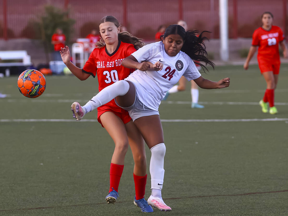 Desert Oasis' Jaelyn Thigpen (24) kicks the ball under pressure from Doral Academy's ...