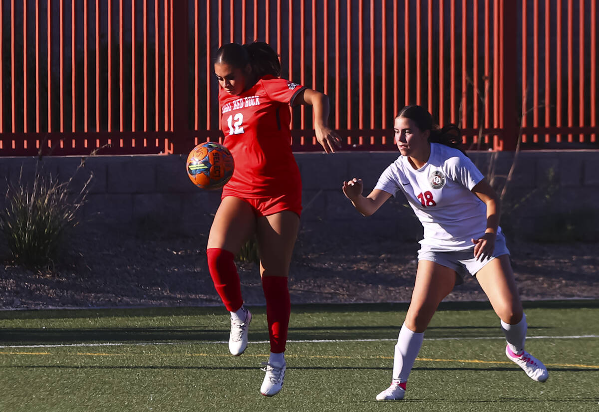 Doral Academy's Dasha Rosas (12) keeps the ball from Desert Oasis' Marissa Williams ( ...