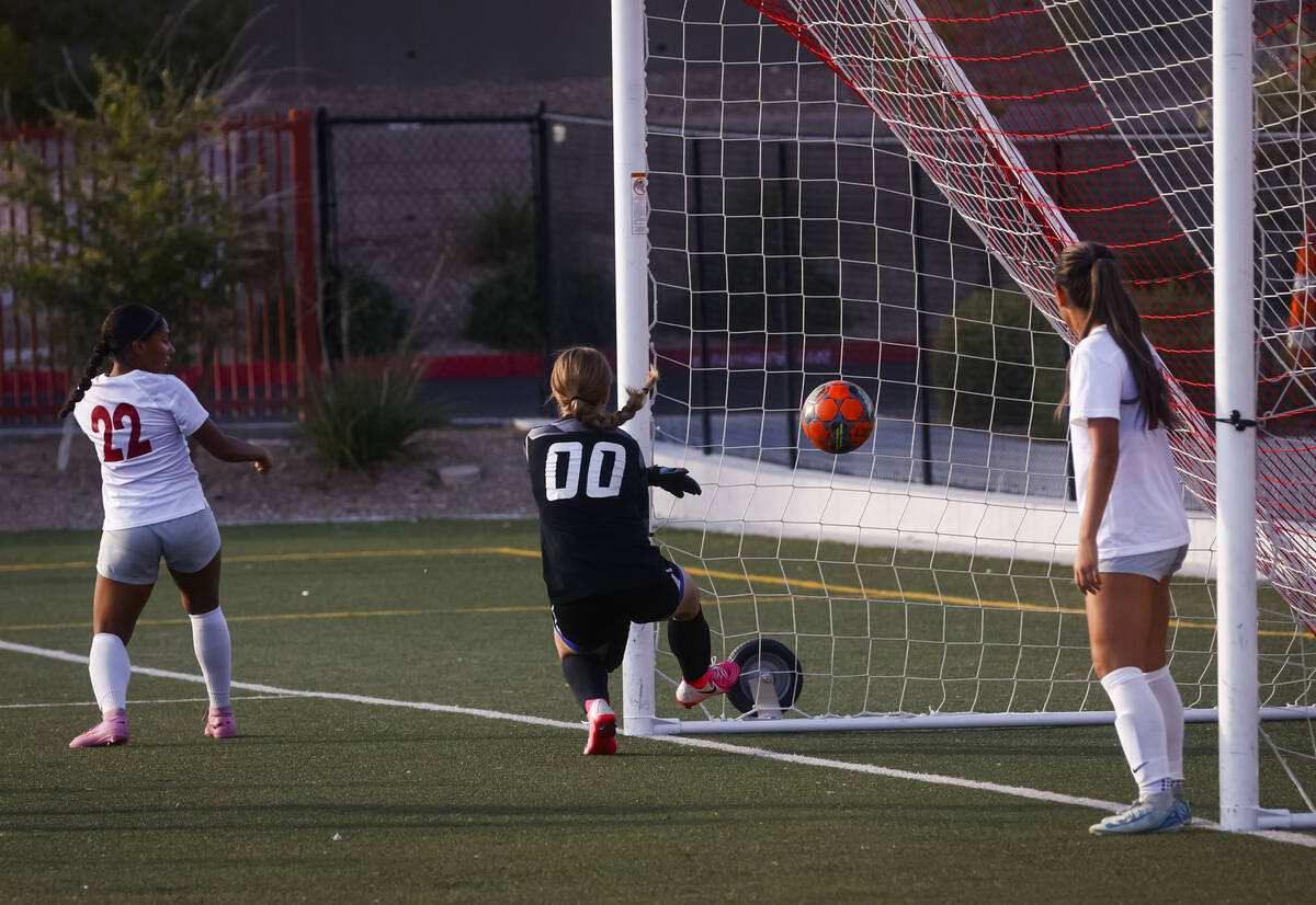 Desert Oasis goalkeeper Rylee Statham (00) tries to stop a shot from Doral Academy during a soc ...
