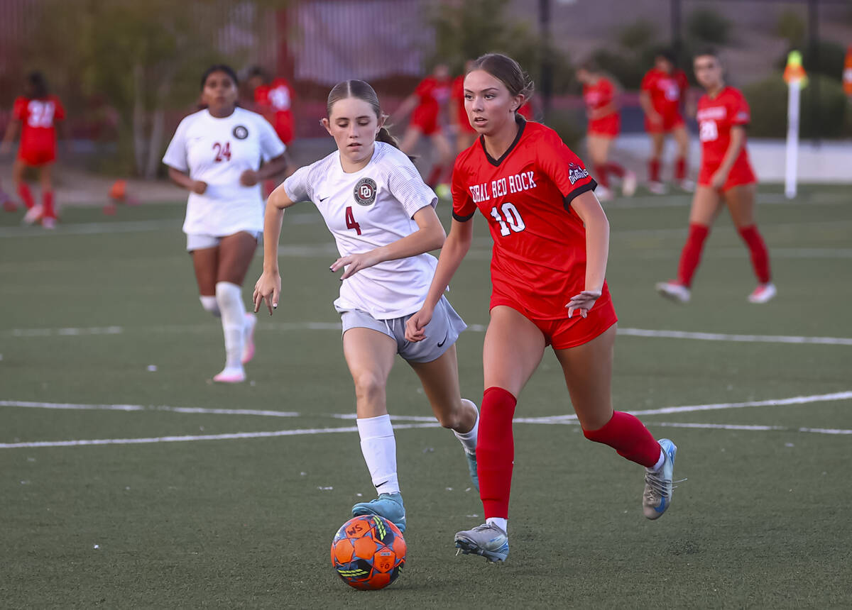 Doral Academy's Chloe Mashore (10) runs with the ball ahead of Desert Oasis' Ava Lyma ...
