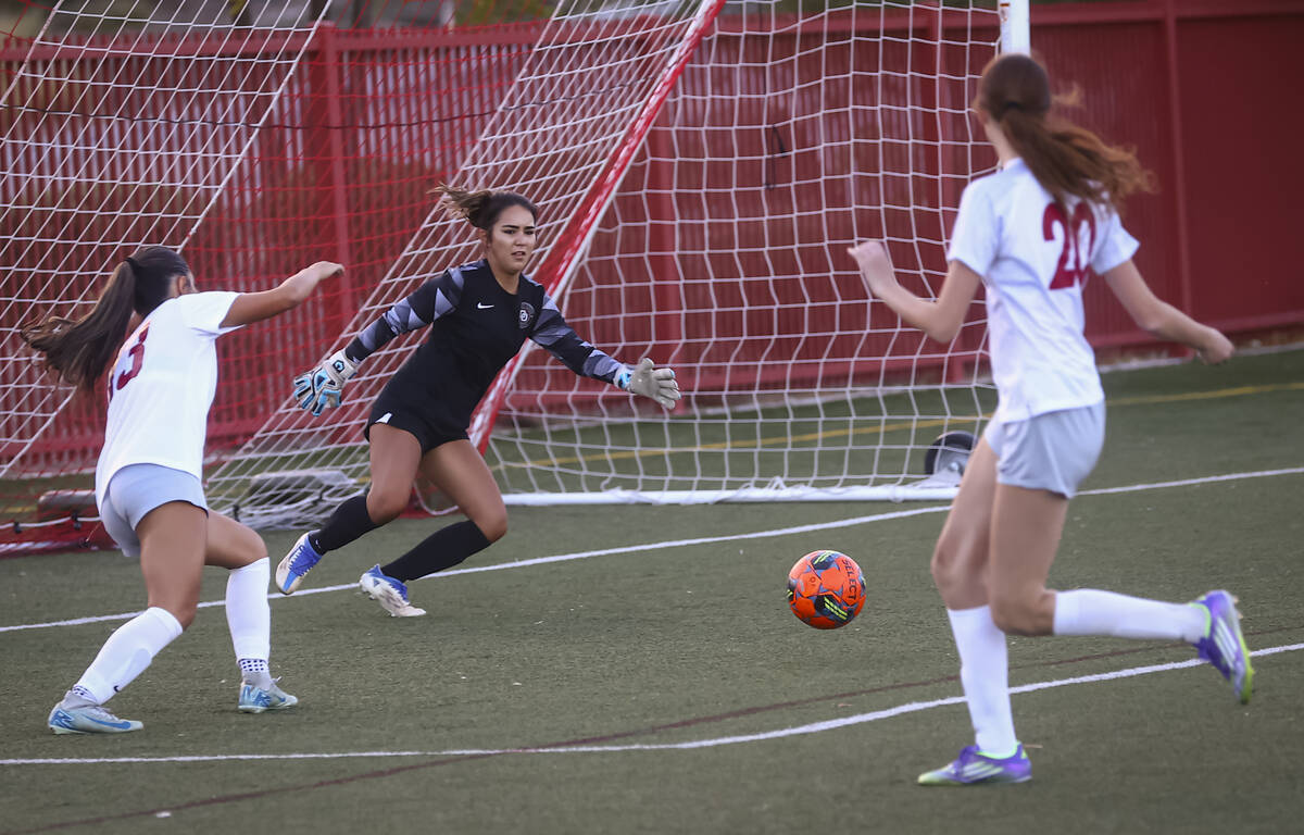 Desert Oasis goalkeeper Faith Parker tries to stop the ball during a soccer game at Doral Acade ...