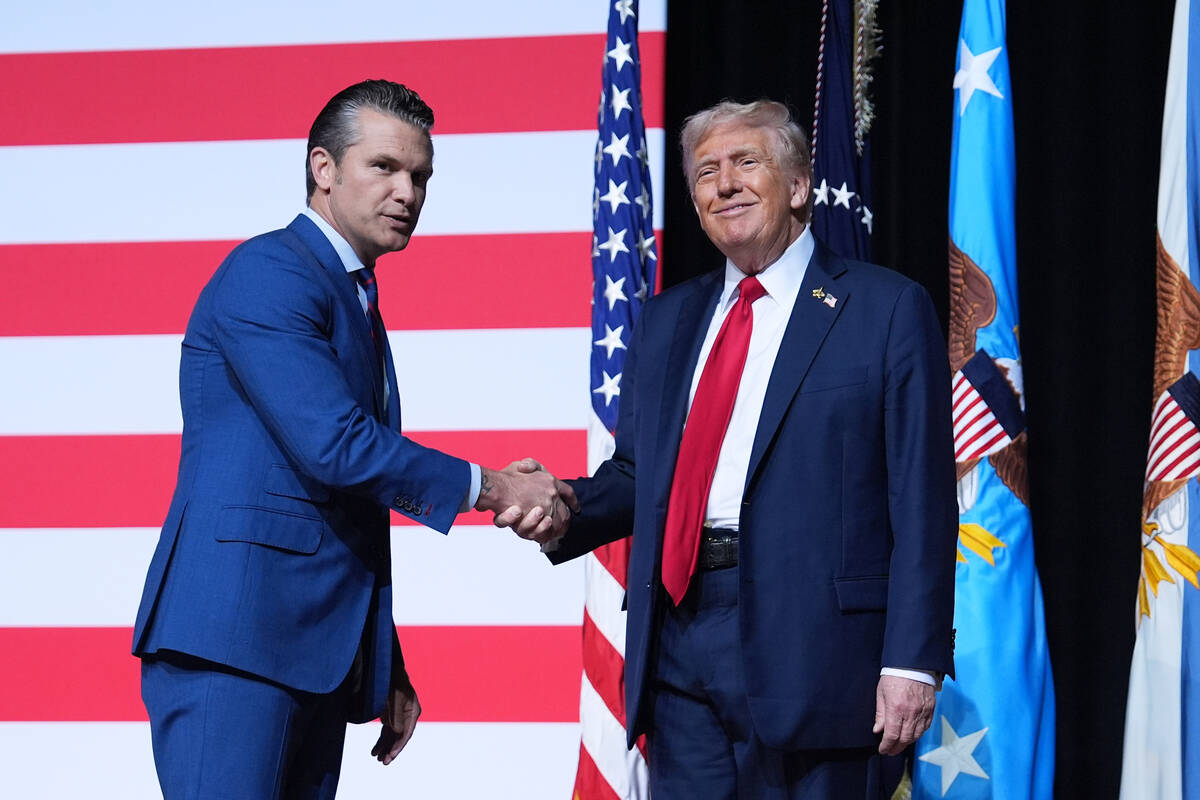 President Donald Trump is greeted by Secretary of Defense Pete Hegseth before speaking to a gat ...