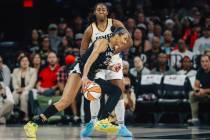 Aces center A'ja Wilson (22) moves the ball to the basket around Indiana Fever forward Ali ...