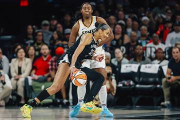 Aces center A'ja Wilson (22) moves the ball to the basket around Indiana Fever forward Ali ...