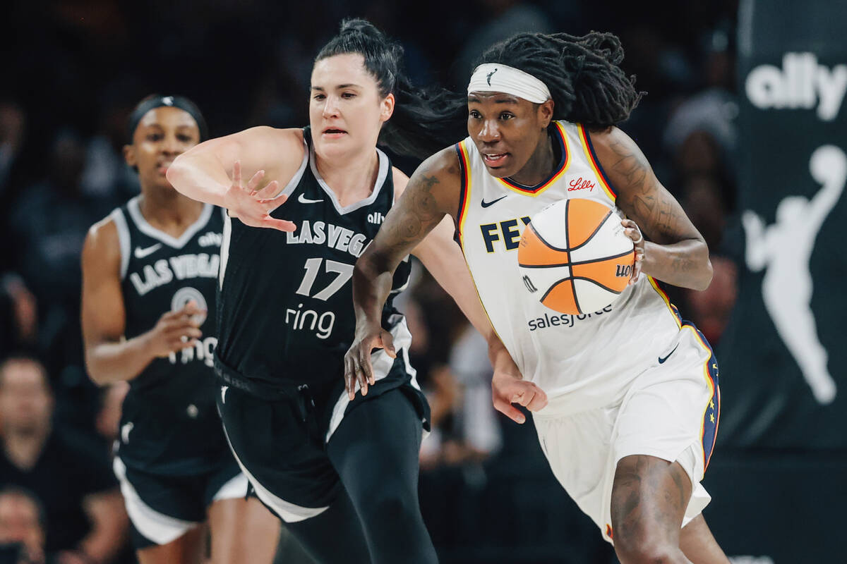 Indiana Fever forward Natasha Howard (6) rushes the ball across the court as Aces center Megan ...