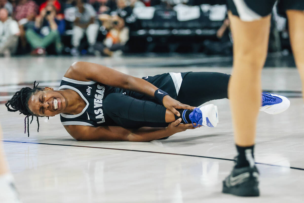 Aces guard Chelsea Gray (12) grabs her leg during game five of a WNBA semifinals series between ...