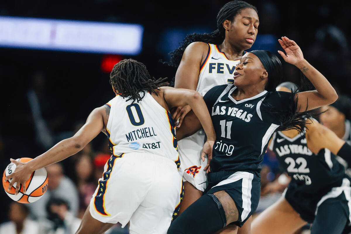 Aces guard Dana Evans (11) defends as Indiana Fever guard Kelsey Mitchell (0) rounds the ball d ...