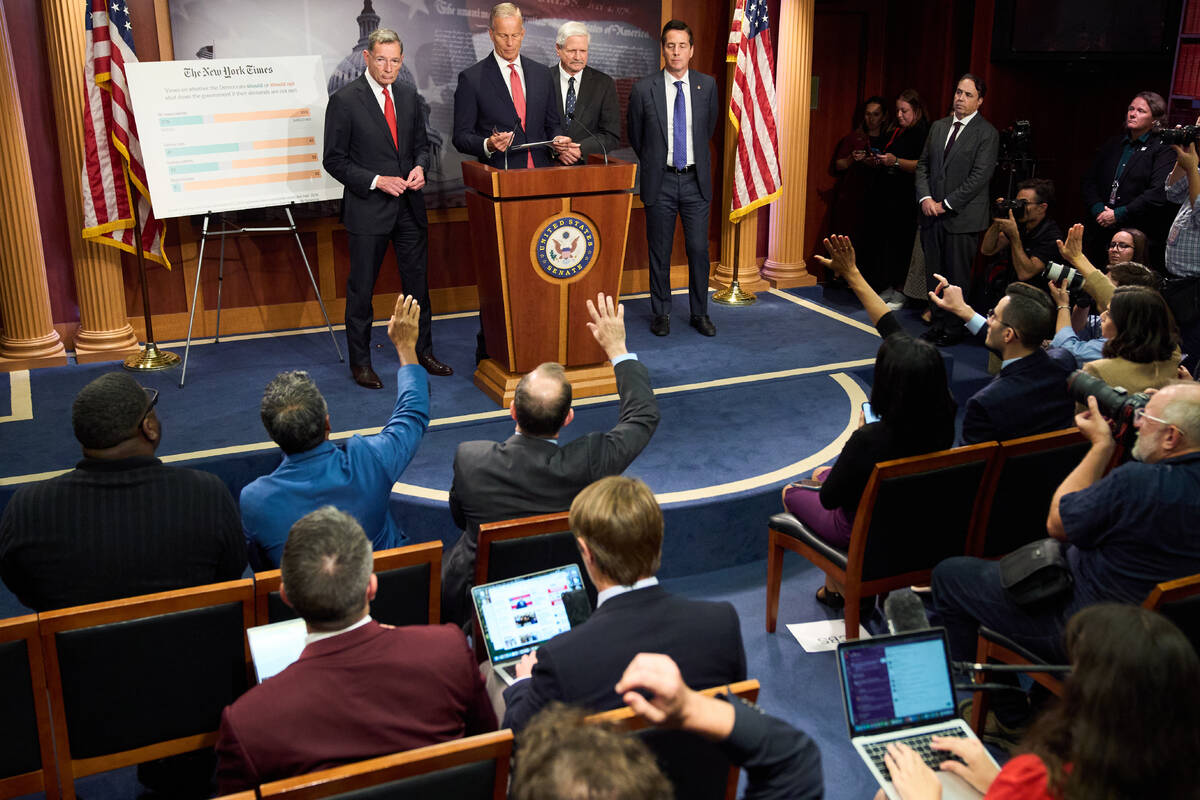 Senate Majority Leader John Thune, R-S.D., center, speaks to reporters about the government shu ...