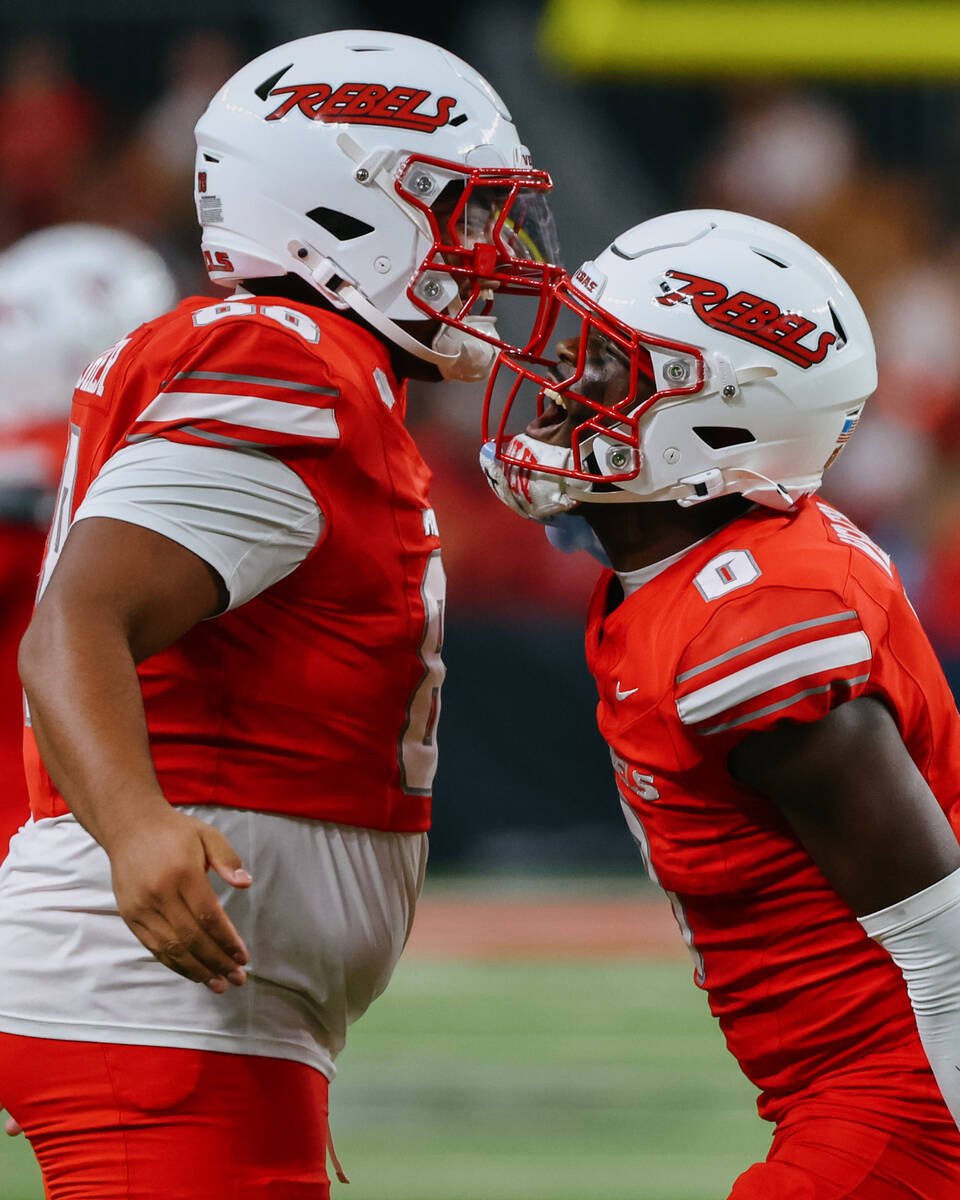 UNLV defensive lineman Mo Abbasher (88) and UNLV defensive back Laterrance Welch (0) celebrate ...
