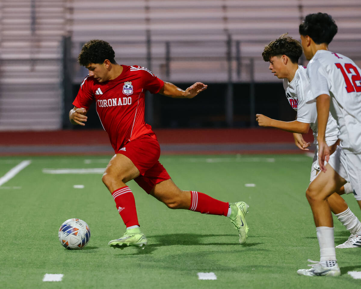 Coronado midfielder Dylan Flores (9) dribbles up the field during the soccer game on Tuesday, S ...