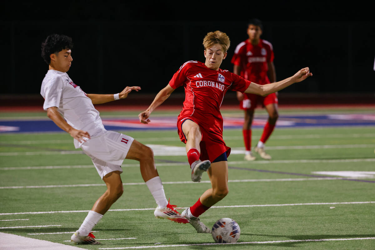 Liberty forward Javier Montes (11) and Coronado midfielder Cy Adams (8) spar for the ball durin ...