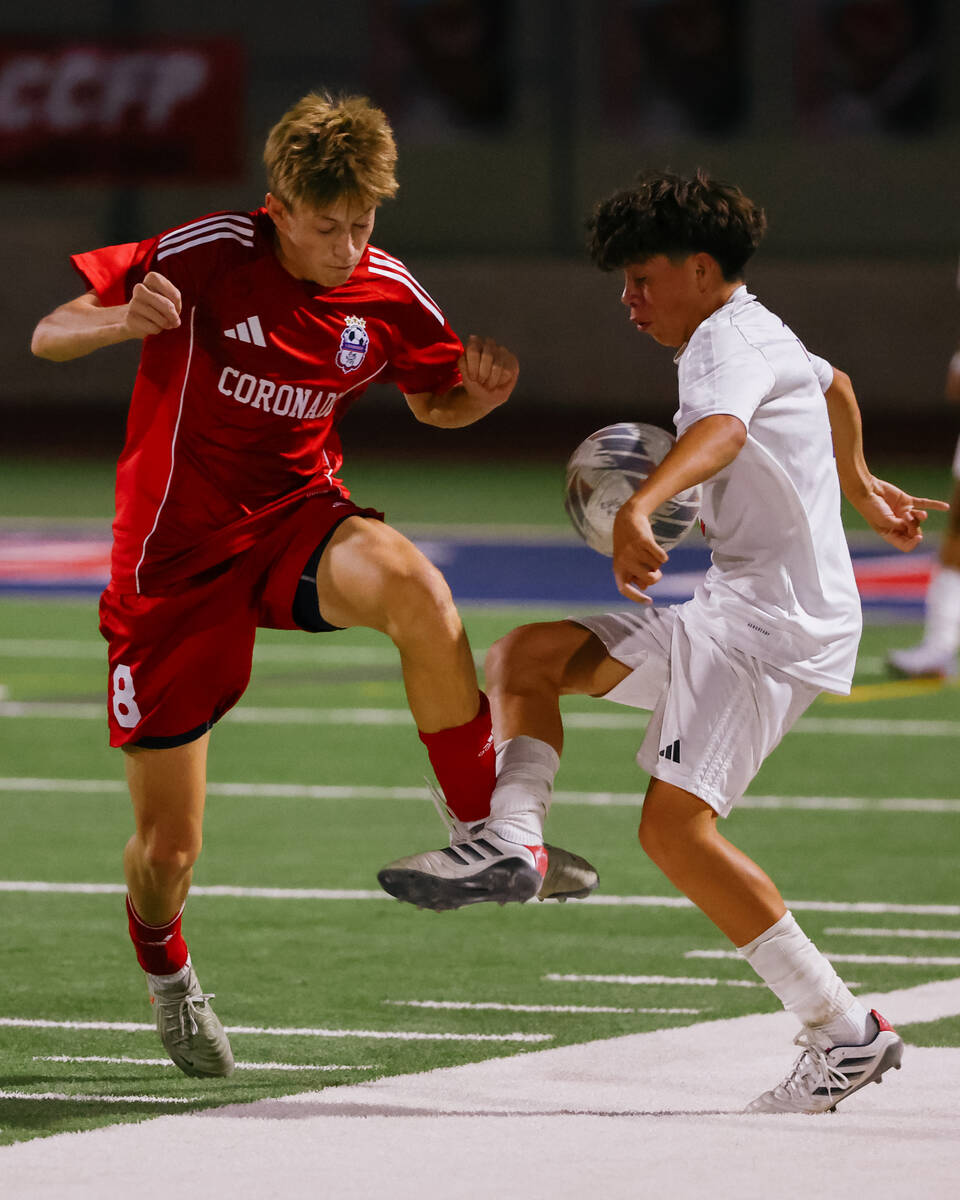 Coronado midfielder Cy Adams (8) and Liberty forward Danny Barrera (1) spar for the ball during ...