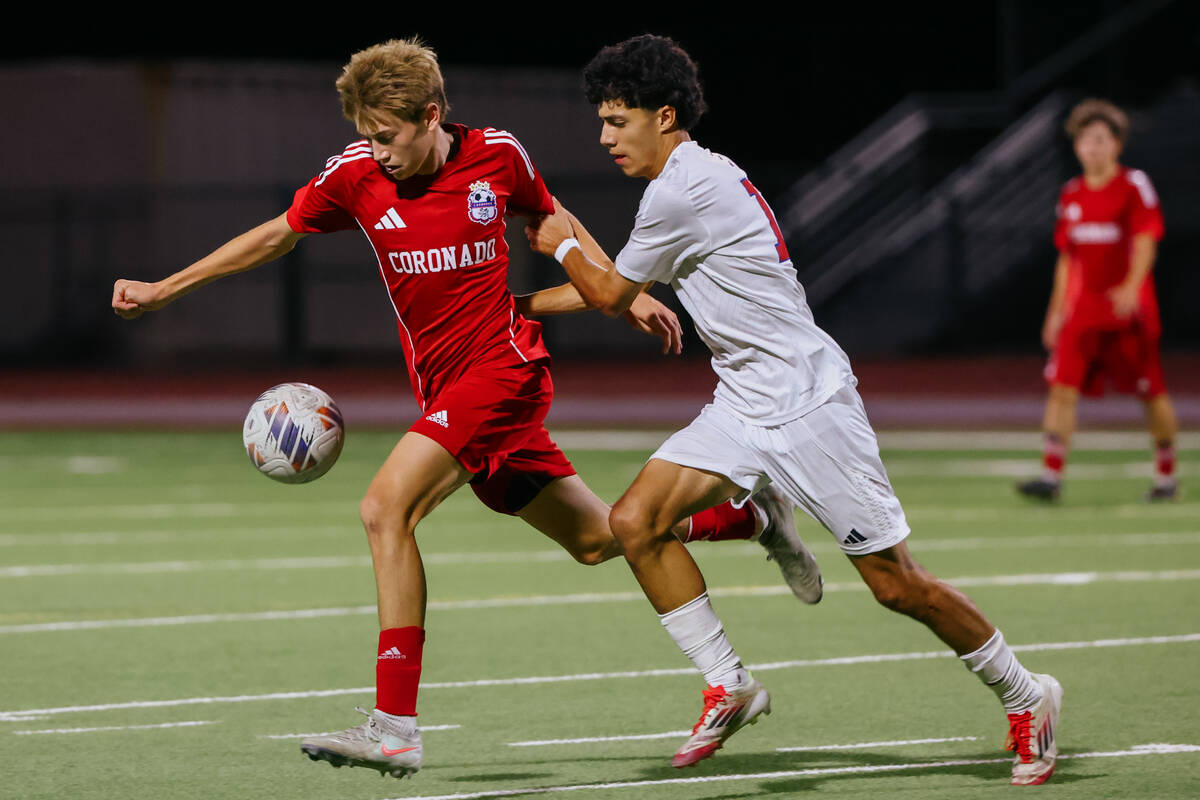 Coronado midfielder Cy Adams (8) tries to control a high ball with pressure from Liberty forwar ...