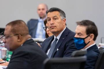 Brian Sandoval, center, president of the University of Nevada, Reno, attends the Board of Regen ...