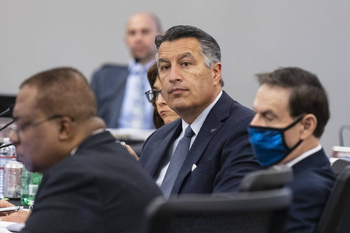 Brian Sandoval, center, president of the University of Nevada, Reno, attends the Board of Regen ...