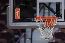 FILE - The WNBA logo and hoop are seen at a WNBA basketball game at Mohegan Sun Arena, Tuesday, ...