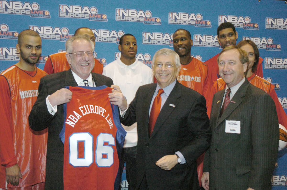 David Stern, (C), the Commissoner of the National Basketball Association, smiles as he hands ov ...