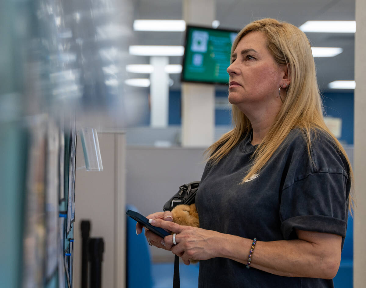 Jae Turney scans a job and resource board at EmployNV Career Hub in Las Vegas Sept. 29, 2025. T ...
