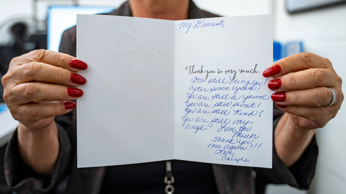 Administrative assistant Zahra Modjarrad shows off a thank you card she received after helping ...