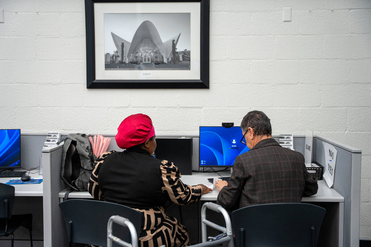 Administrative assistant Zahra Modjarrad helps job seekers complete tasks on the computer at Em ...