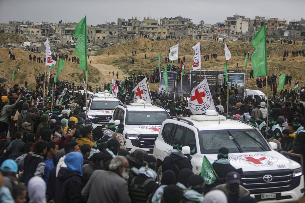 Red Cross vehicles arrive to collect coffins containing four bodies to be handed over by Hamas ...