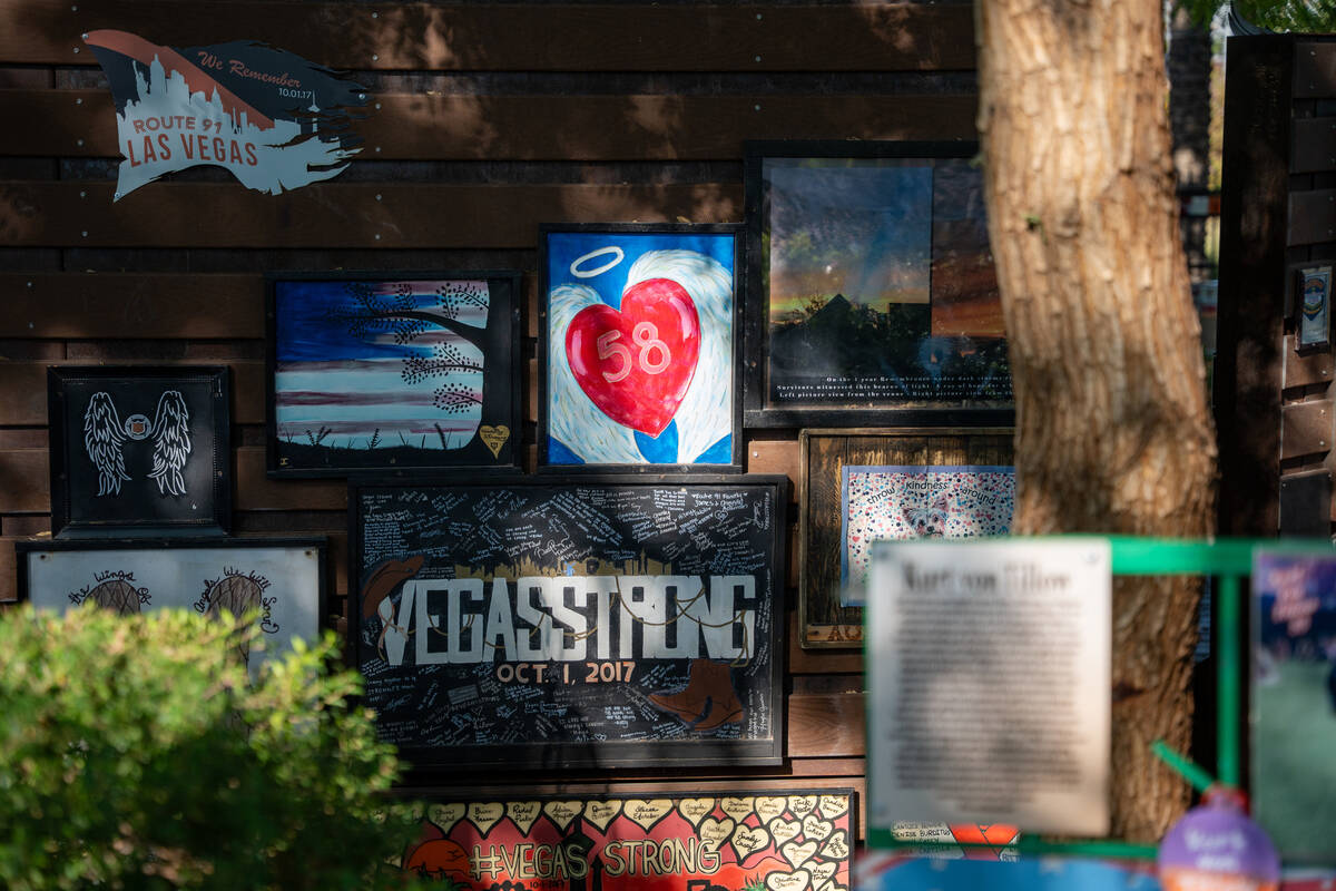 Painted images hang on the back of the remembrance wall at the Las Vegas Community Healing Gard ...