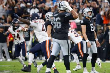 Chicago Bears players celebrate while Raiders kicker Daniel Carlson (8) and defensive tackle Jo ...