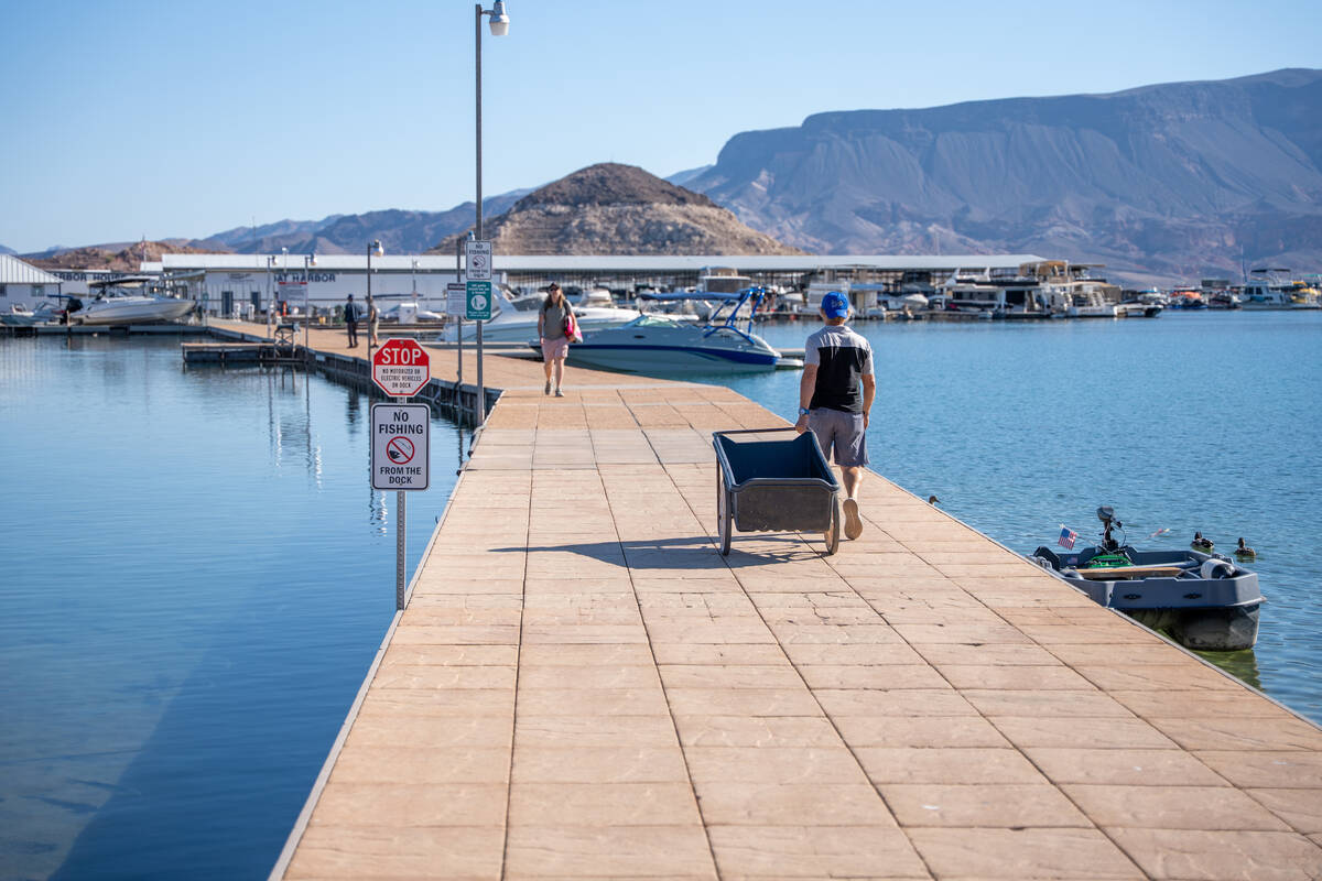 Visitors walk along a dock at Lake Mead National Recreation Area due to the government shutdown ...