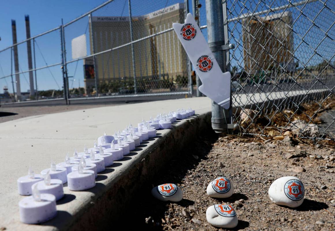 Candles and rocks are placed on Wednesday Oct. 1, 2025, at the site where 58 people were killed ...