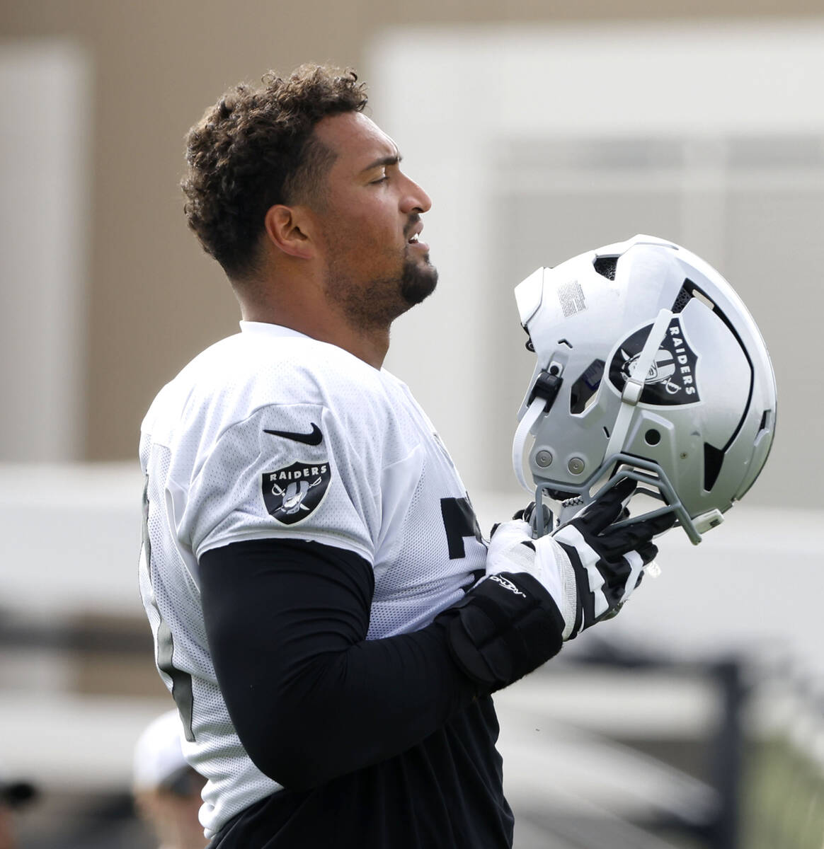 Raiders offensive tackle Stone Forsythe (70) prepares to put his helmet on prior to the start o ...