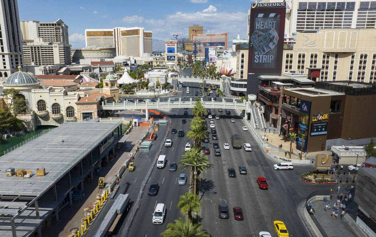 Workers install grandstands, left, in front of the Bellagio Fountains for the 2025 Formula One ...
