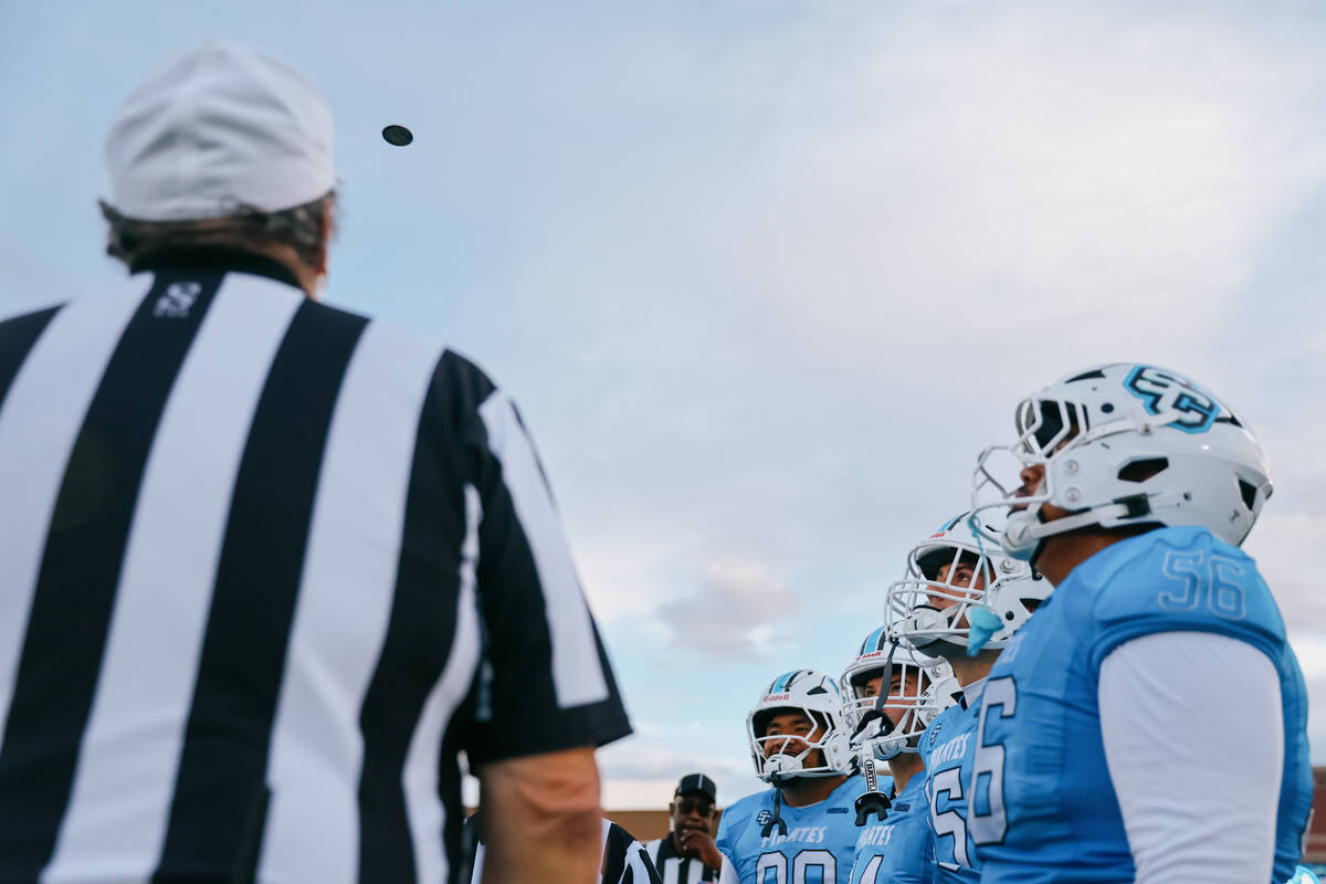 Sloan Canyon’s captains watch the coin flip before a football game against Spring Valley ...