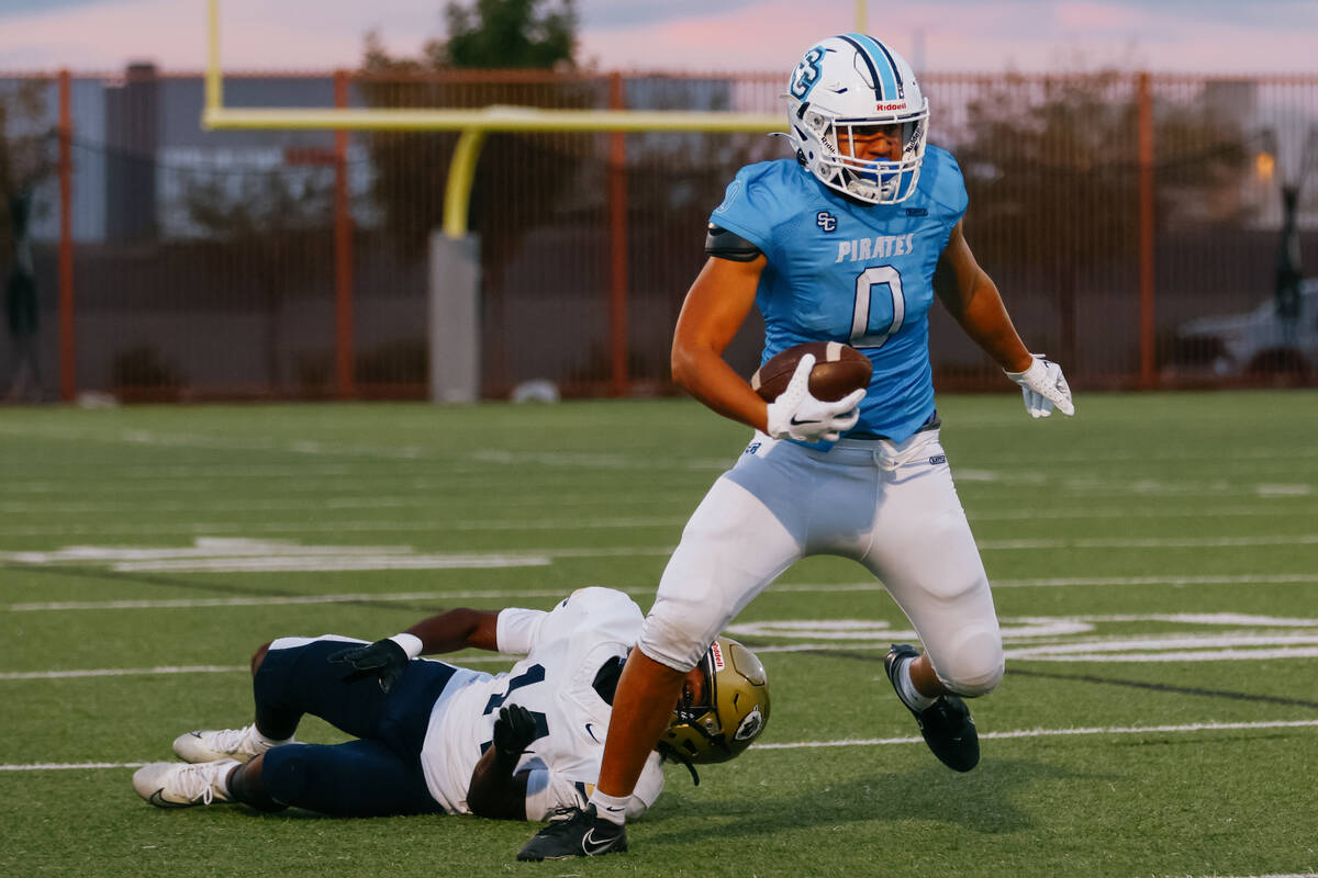 Sloan Canyon tight end Kame’e Sawyer-Mahoe (0) dodges Spring Valley defensive back Johnn ...