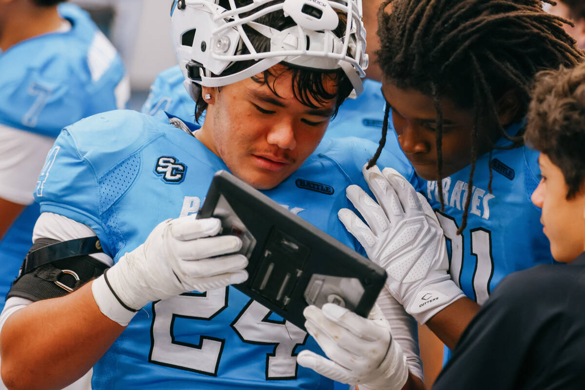 Sloan Canyon’s La'iku Kamali'i Kahakauwila (24) and Jordan Frost (91) review t ...