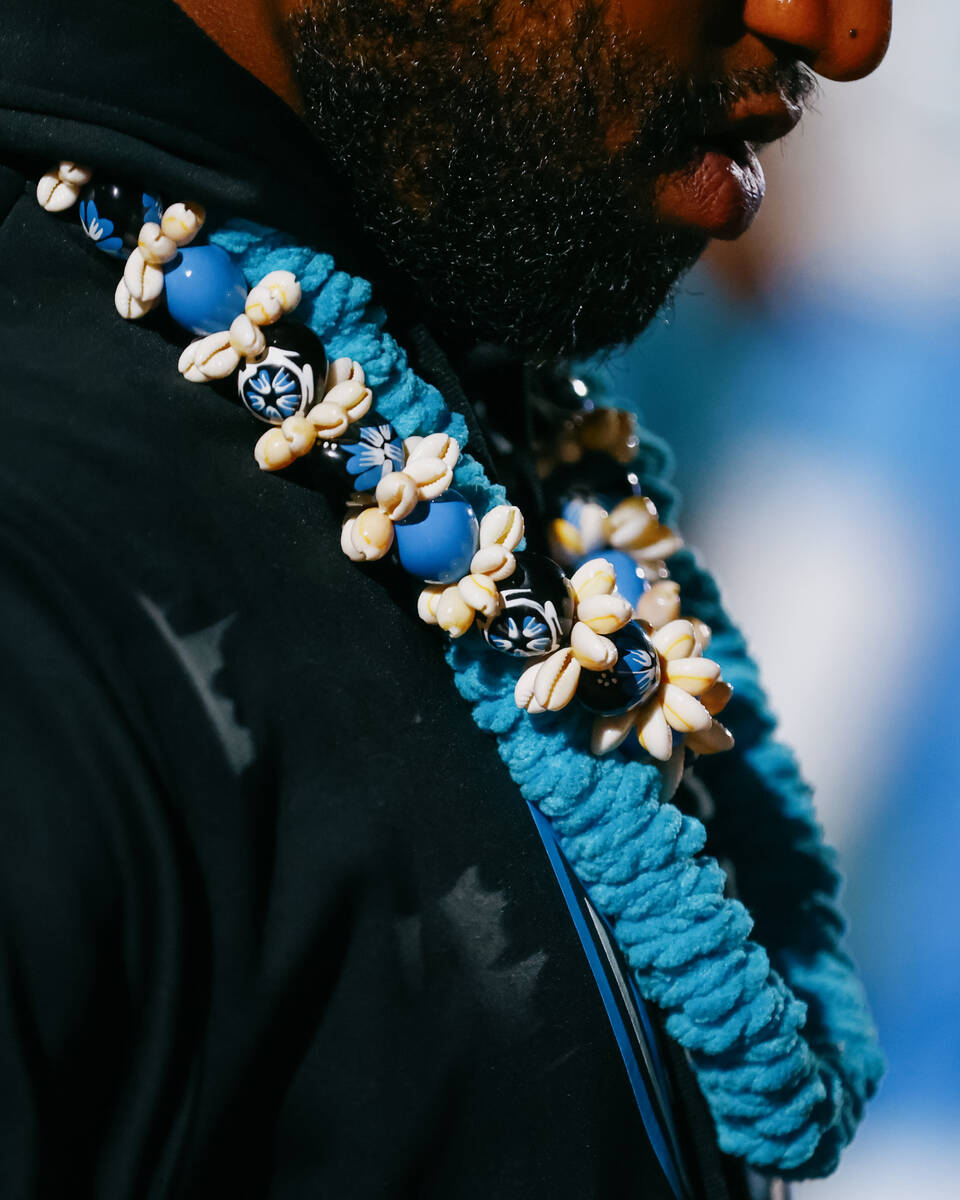 Sloan Canyon assistant coach JD Alexander wears leis with beads and shells while coaching a foo ...