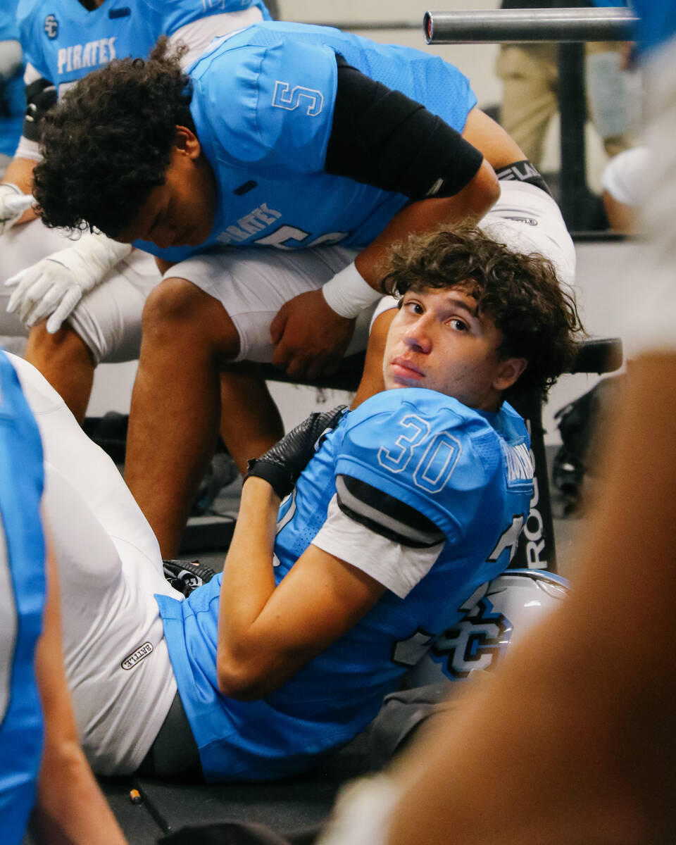 Sloan Canyon defensive back Mason Paul listens to coaches speak in the weight room during halft ...